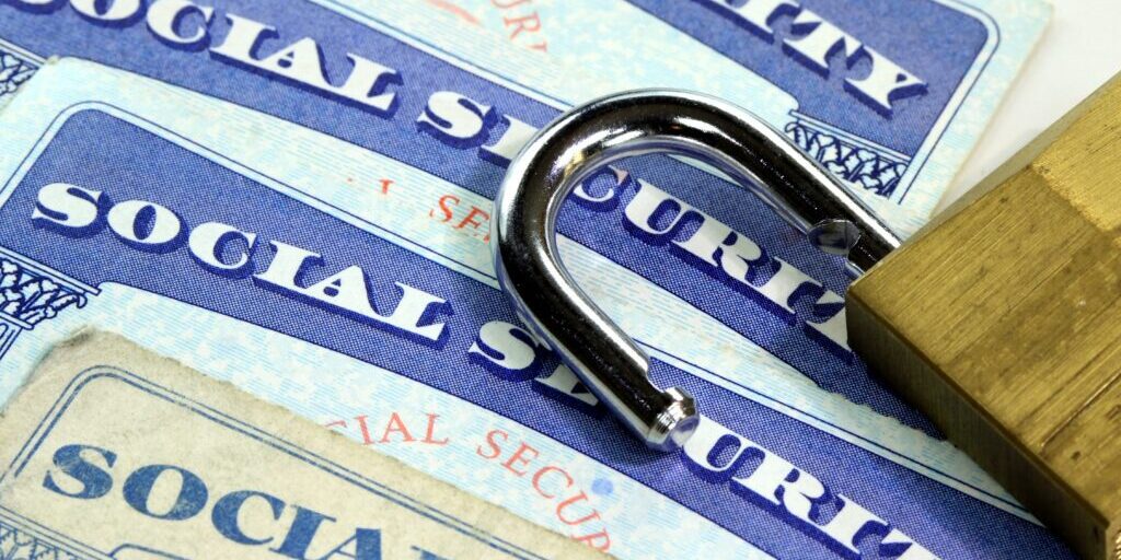 Padlock and Social Security card - Identity theft and identity protection concept
